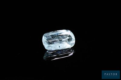 a close up of a blue diamond on a black surface