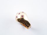 an image of a gold ring with purple stones on it