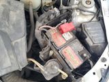 a car engine with the hood open and a car battery in it