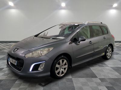 the grey car is parked on a checkered floor in the garage