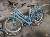 two bicycles parked next to each other on the sidewalk