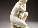 statue of a man sitting on a marble base with his hands on his knees