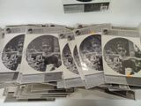 a lot of old black and white photos on a table