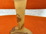 a glass vase that is sitting on an orange chair