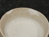 a small bowl of water sitting on a table