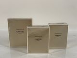 three boxes of chanel perfume sitting on top of a table