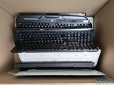 a cardboard box with a bunch of computer keyboards in it
