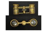 pair of antique brass binoculars on a black background