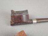 a pipe that is sitting on a table next to a piece of wood