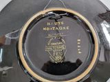 a black plate with a gold trim and a black plate with a gold trim