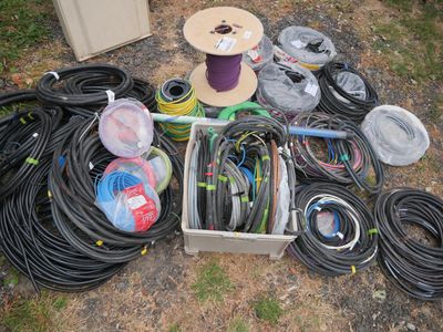 many different types of hoses and spools laid out on the ground