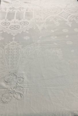 a white bed with a white comforter and a white pillow