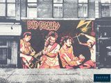 a painting of a band on the side of a building