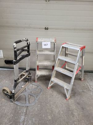 two ladders sitting next to each other in front of a garage door