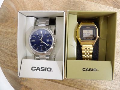two watches in a box on a table