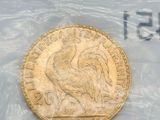 a gold coin with a rooster on it in a plastic bag