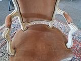 a chair that is sitting on a rug in a room