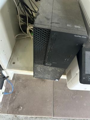 a computer sitting on top of a desk next to a monitor