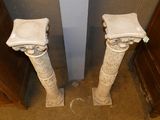two marble pedestals in the corner of a room