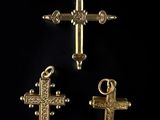 three gold crosses on a black background