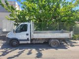 a white truck parked in front of a tree