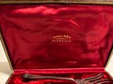a red box with a silver fork and spoon in it