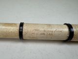 a pipe with writing on it sitting on a table