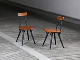 two chairs that are sitting in the middle of a room