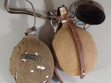 two bottles of wine and a bottle opener hanging from a hook