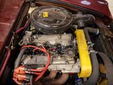 a red car with a yellow engine in the trunk
