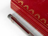 a red box with a pen on top of it