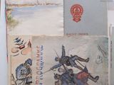 some old postcards are sitting on a table with a flag