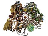 a pile of assorted beads and necklaces on a white surface
