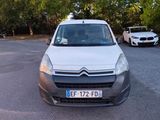 a white van parked in a parking lot next to a white car