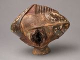 an image of a vase with a fish head on it