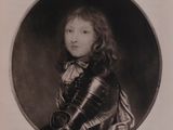 an old black and white photo of a young boy in armor