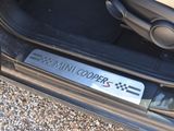 a close up of a car door handle with a mini cooper sticker on it