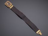 a gold plated wrist watch with a brown leather strap