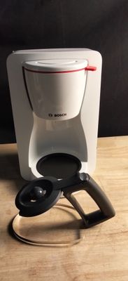 a coffee maker that is sitting on a wooden table