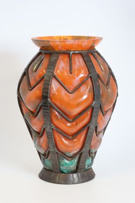 a vase that is sitting on a white surface