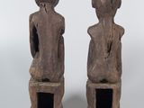 pair of carved wooden figures of a man and a woman