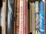 many books that are on a shelf in the library