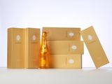 bottles of champagne and boxes on a white surface with a white background