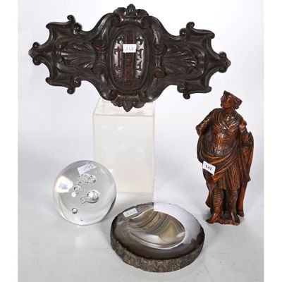 une statue représentant un homme debout à côté d'une horloge et d'autres objets