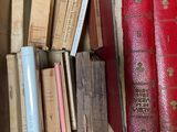 a box full of old books on a shelf