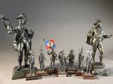 a lot of statues that are on display on a table