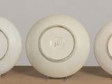 three white plates sitting on top of a table next to each other