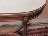 a marble top coffee table on a rug on the floor