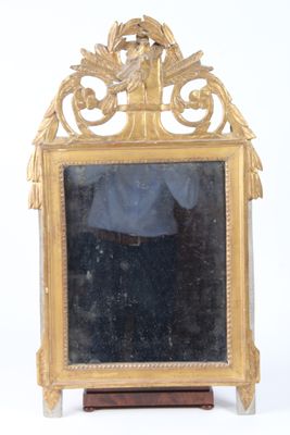a mirror that is sitting on a stand on a white surface