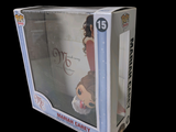 a box with a doll inside of it on a black background